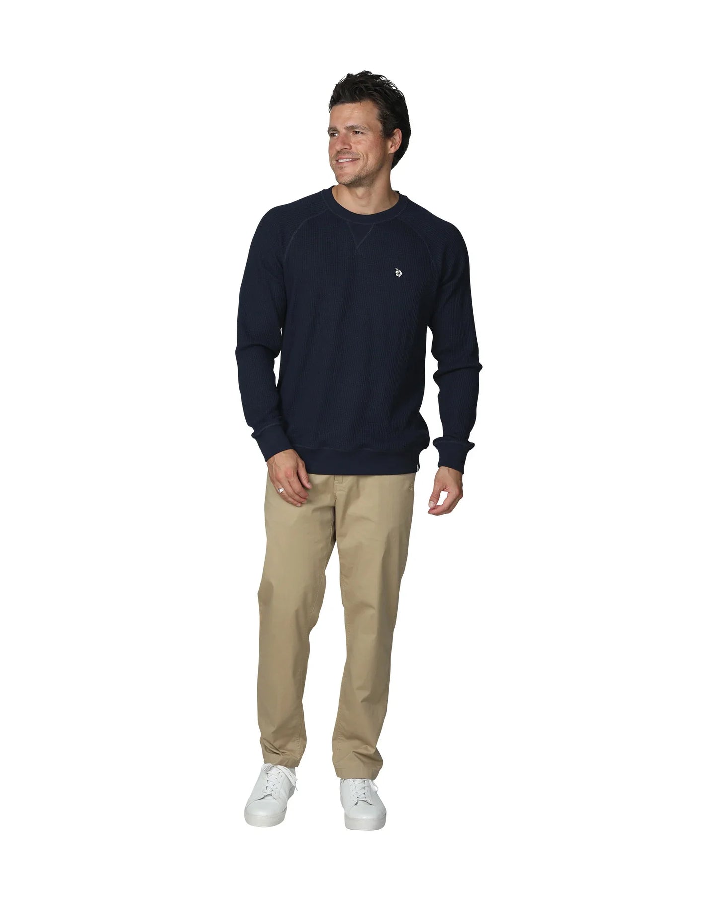 Full body look away front view of a male model wearing the Okanui Long Sleeve waffle knit jumper in Navy