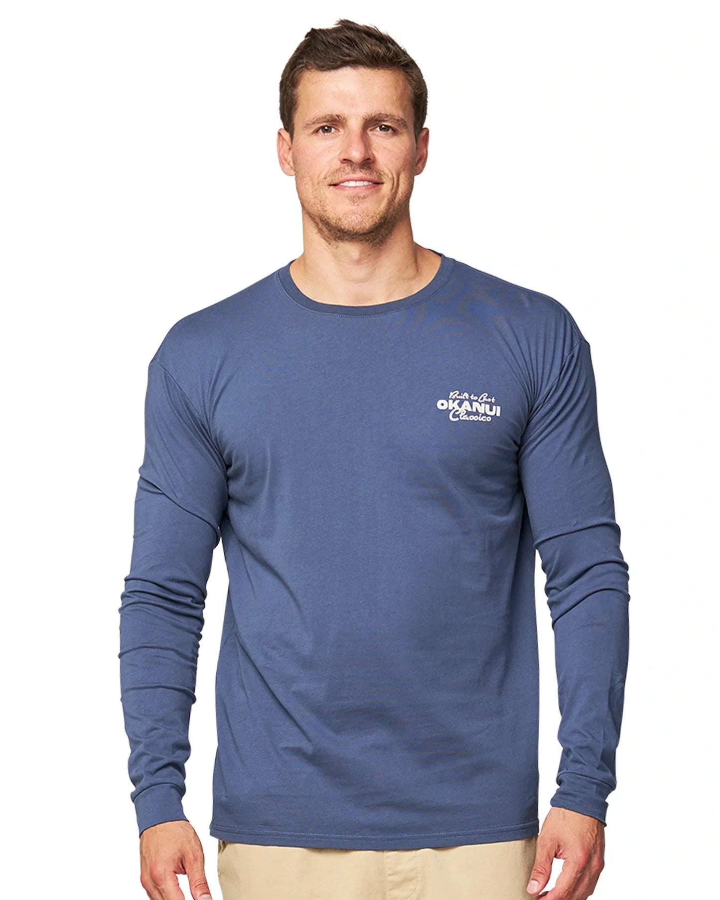 Close up front view of a male model wearing the Okanui Last Stand long sleeve t-shirt in Washed Navy color