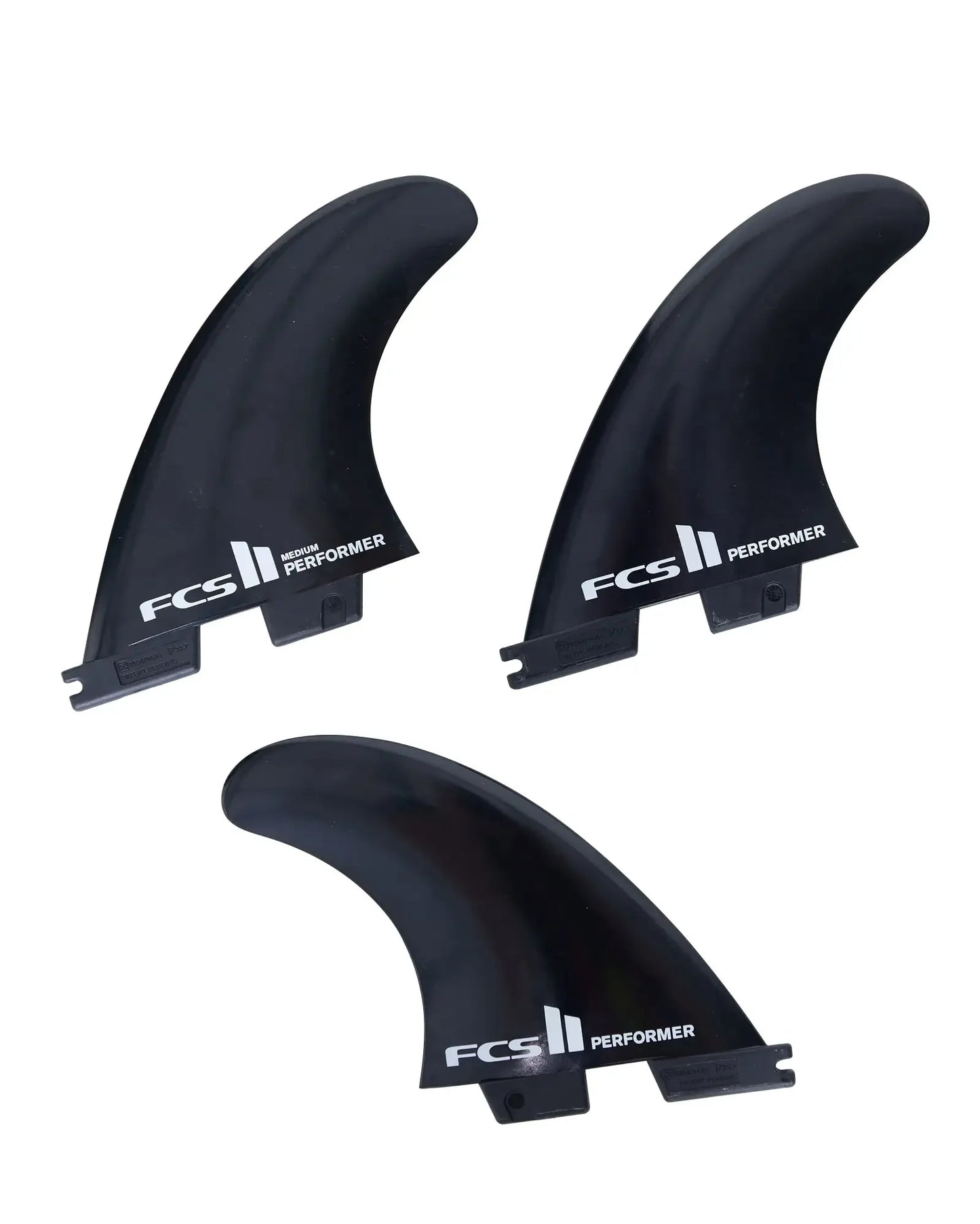 Three FCS Performer surfboard fins