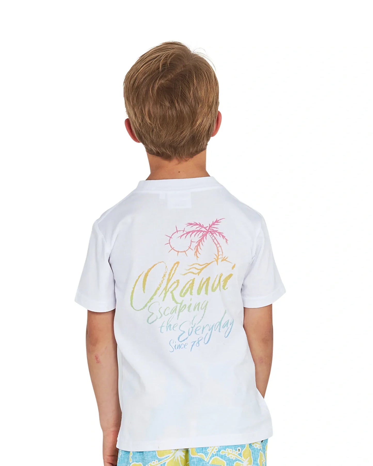 Back view of a little boy wearing the Okanui Rising Sun Tee T-shirt in White