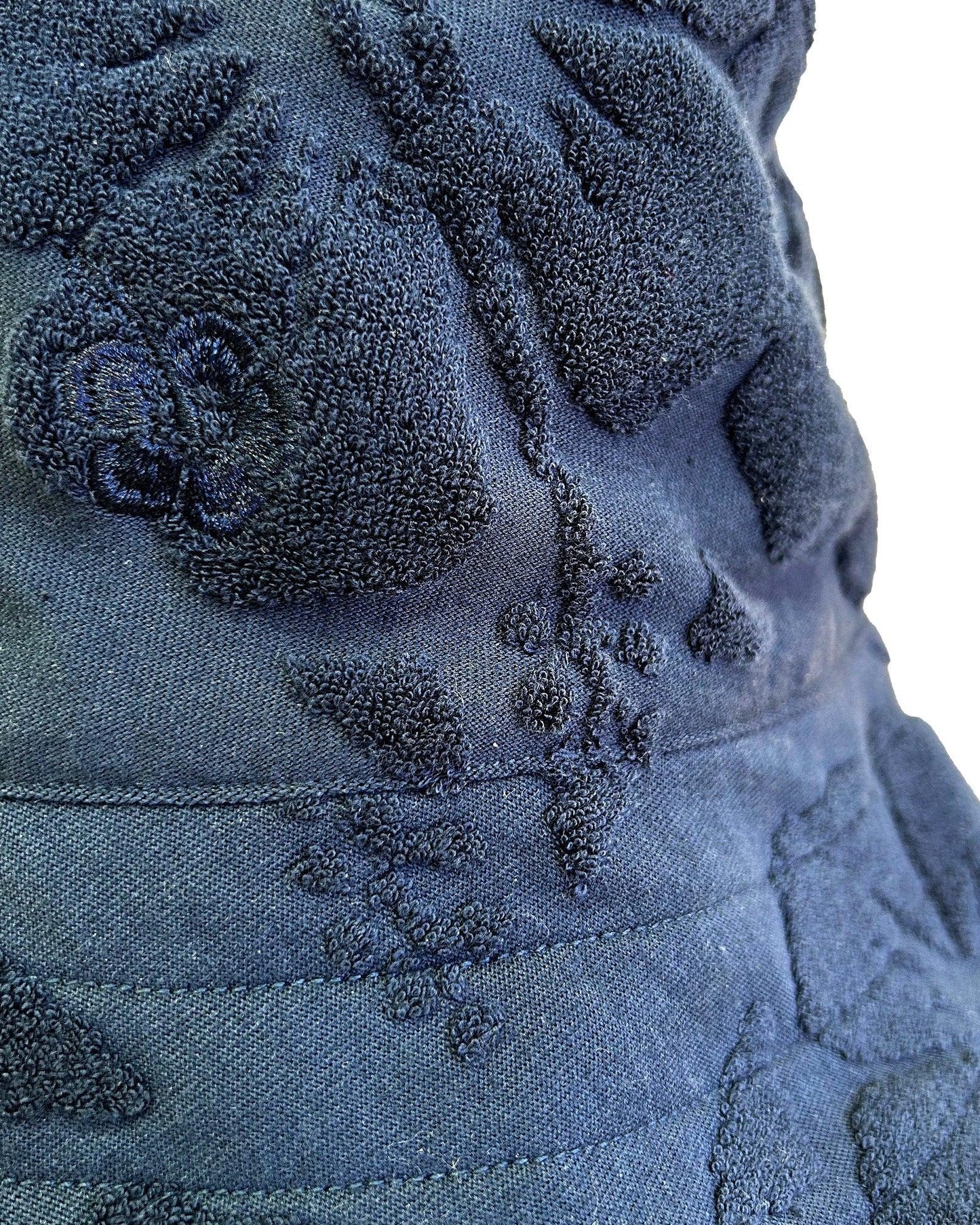 Close up details of the Okanui Weekender Terry Bucket hat in Hibiscus Navy