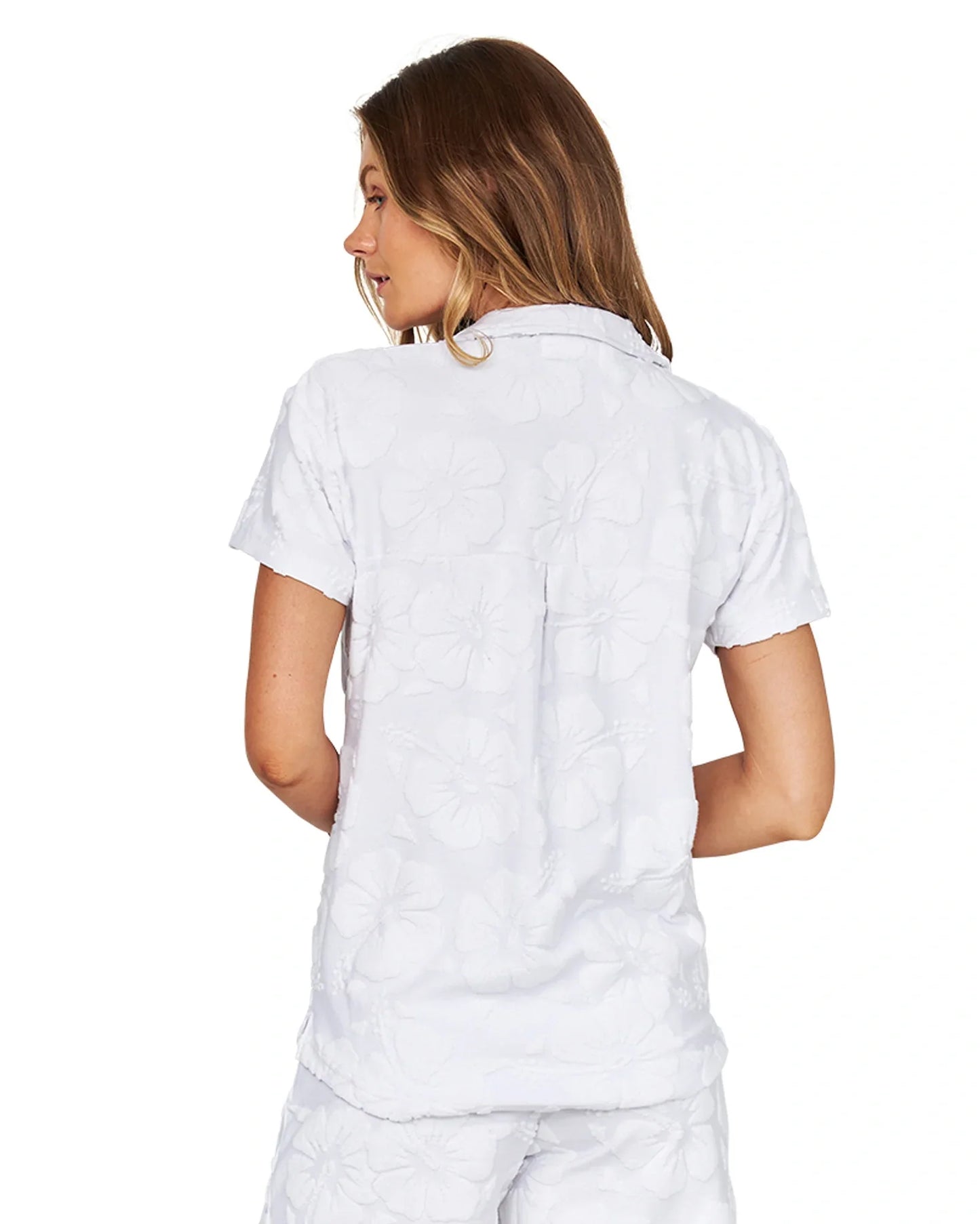 The white Okanui Summer Terry shirt reveals the details on the back.