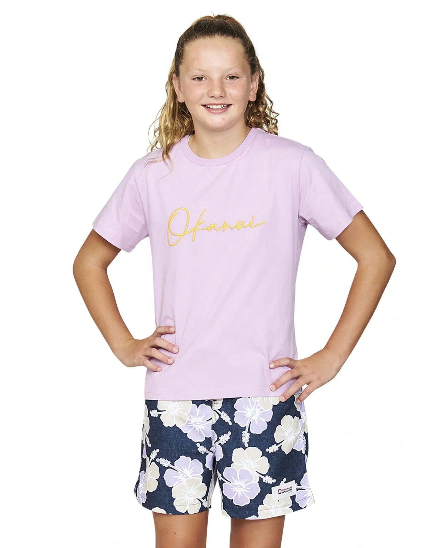 Front view of a girl wearing the Okanui Way Back When kids swim shorts in Navy Lilac