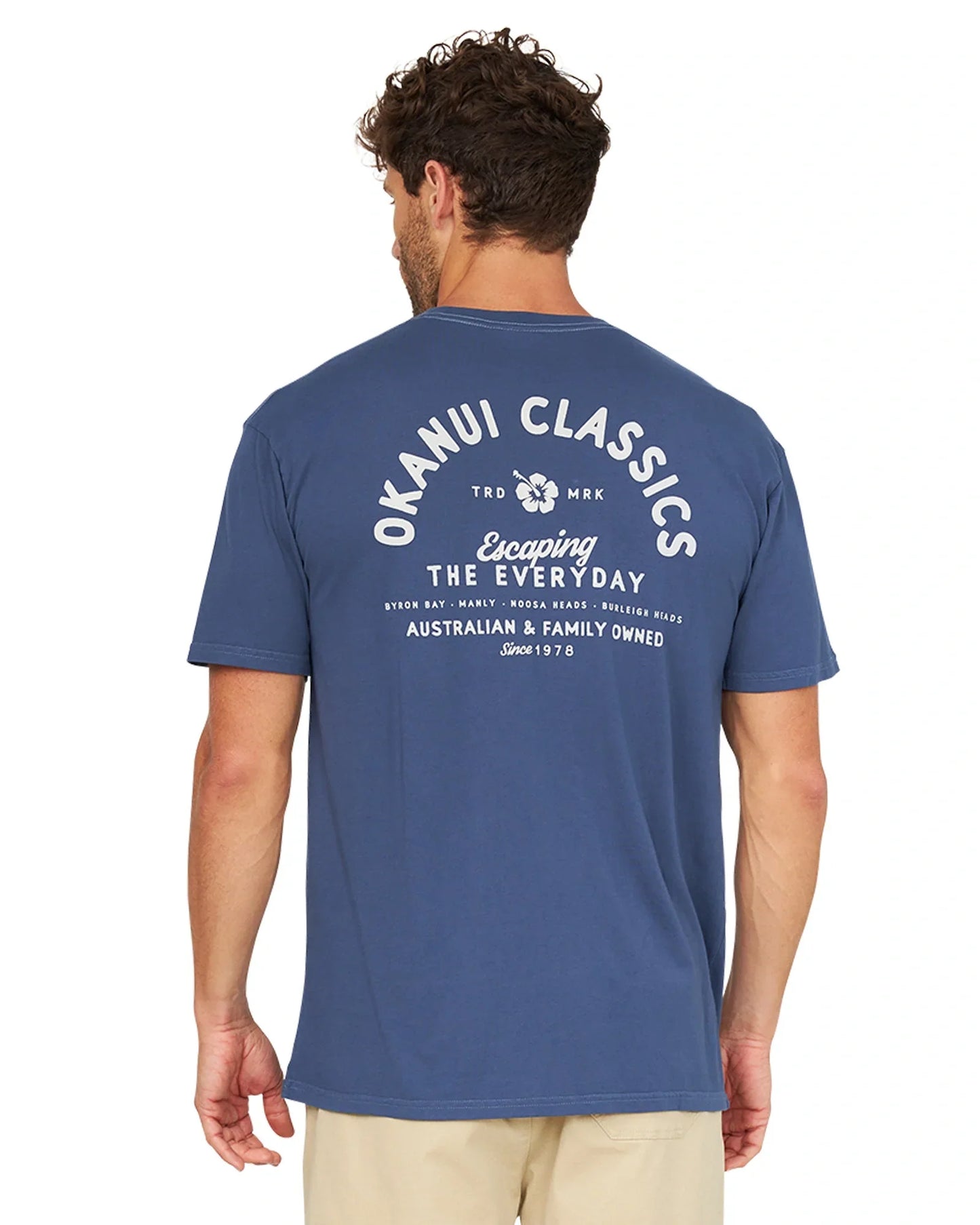 Back view of a male model wearing the Okanui Classic Lock Up T-Shirt in navy.