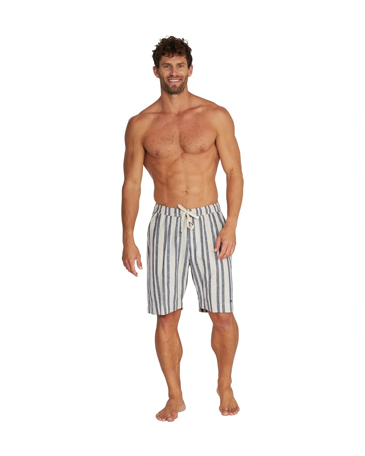 A fit male model wearing the Okanui Old Daze Walk Short in Natural Navy colour.