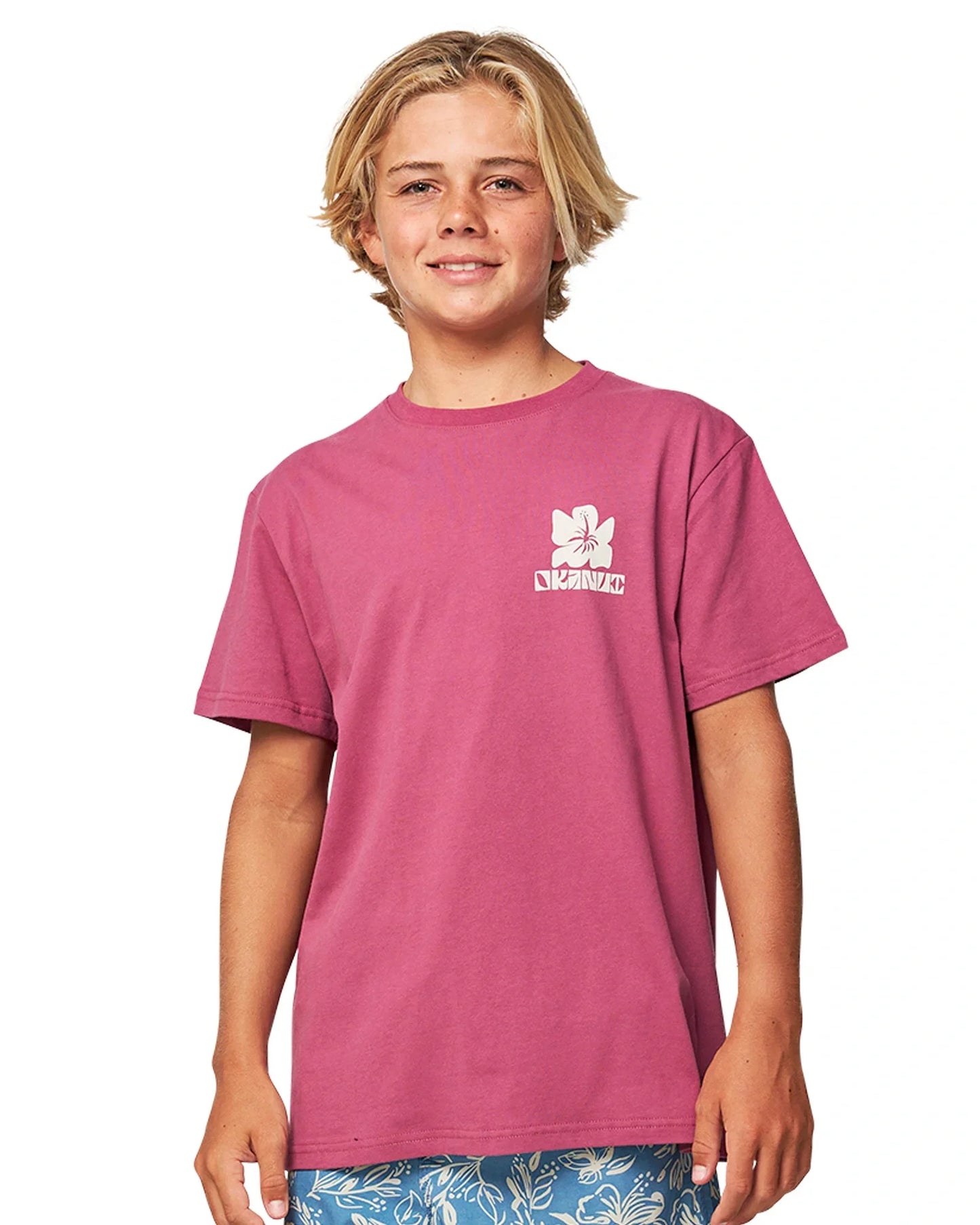 Closeup front view of a boy wearing the Okanui Jungle Tee T-shirt in Garnet