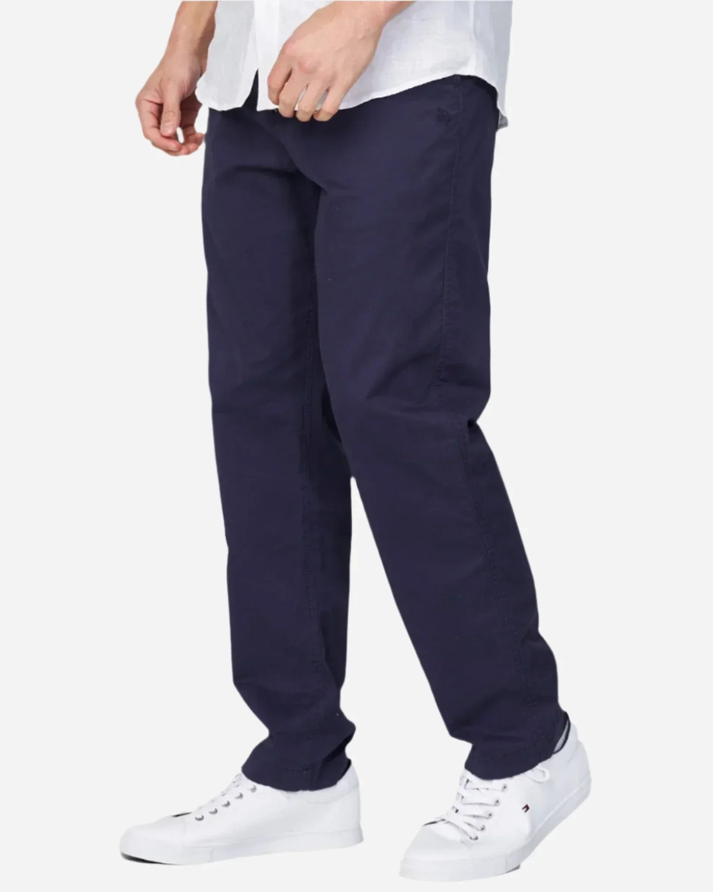 The Okanui Wilson Chino Pants in navy colour as worn with a shirt and shoes.