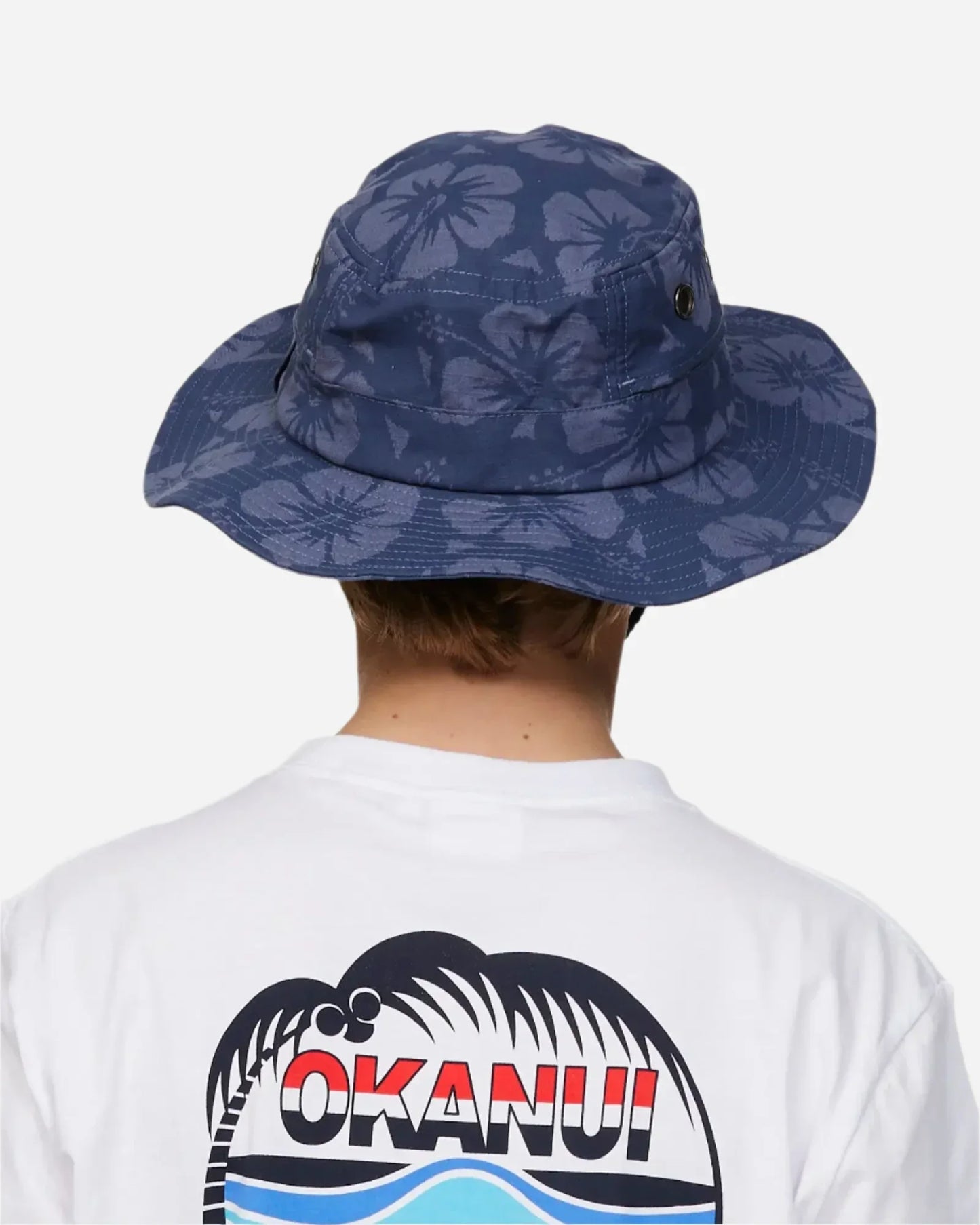 Back view of a boy model wearing the Okanui Bucket hat in Hibiscus Iron