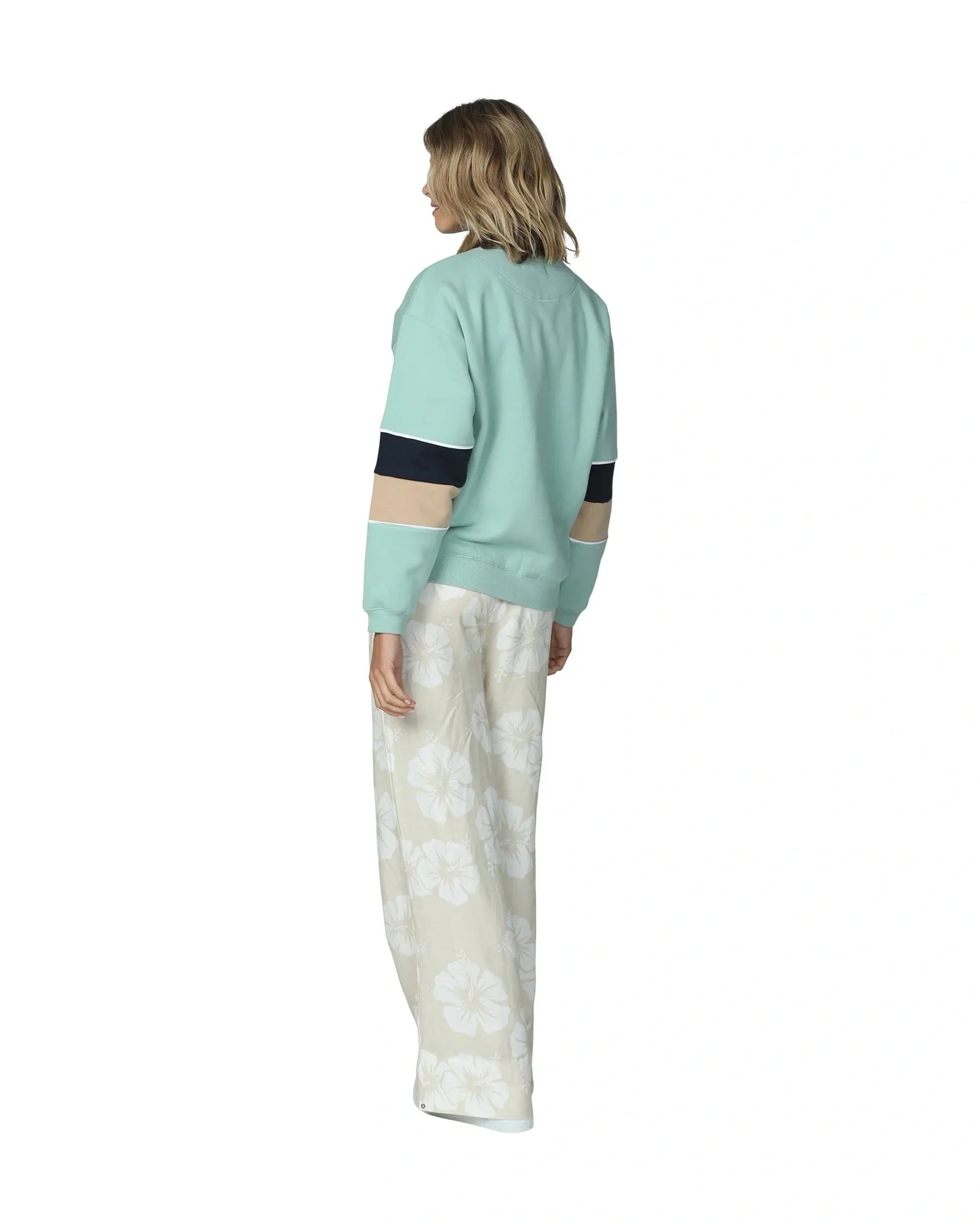Women's sage colored sweater showing the side part.