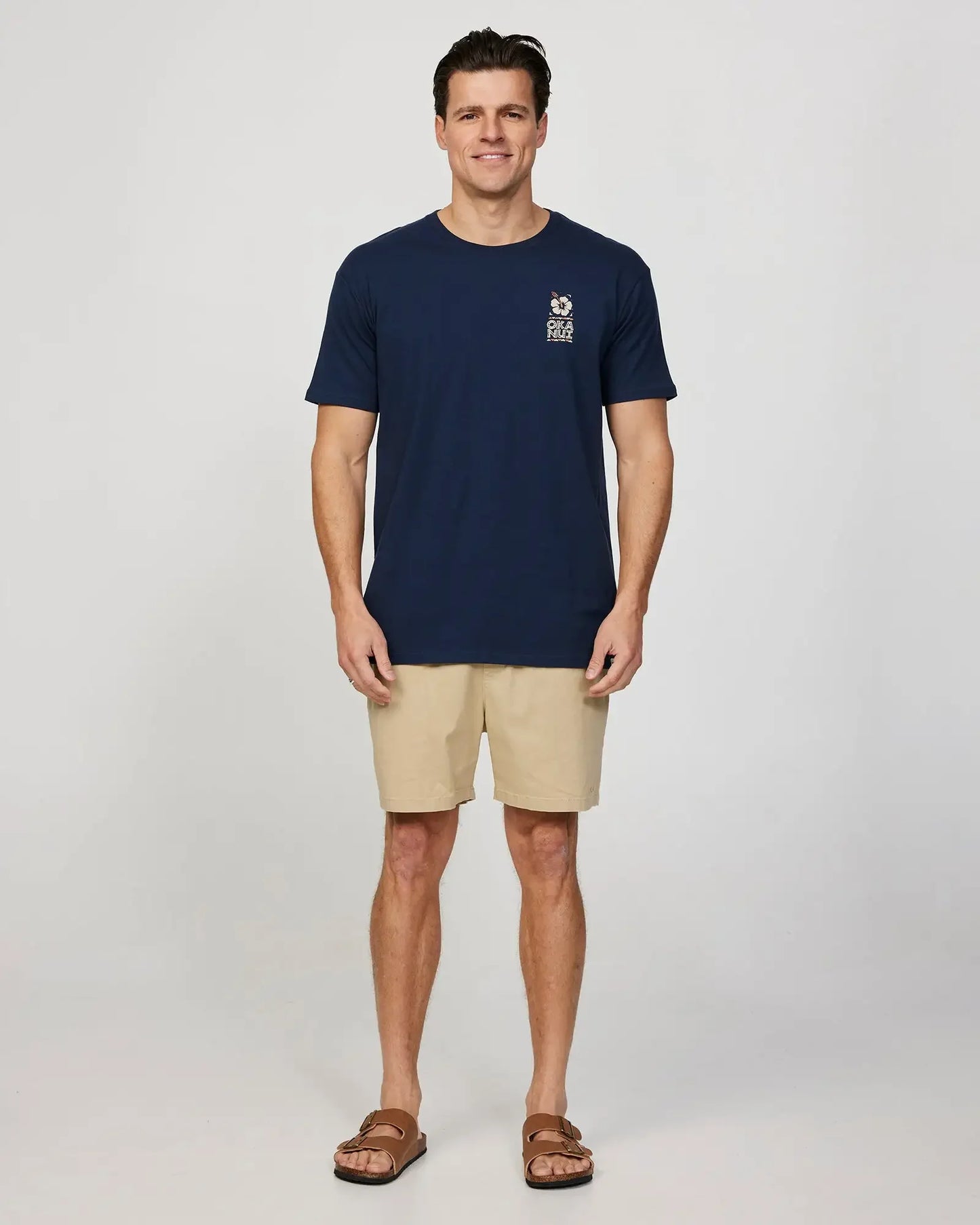 Full body front view of a male model wearing the Okanui Mens Breeze Tee T-shirt in Navy