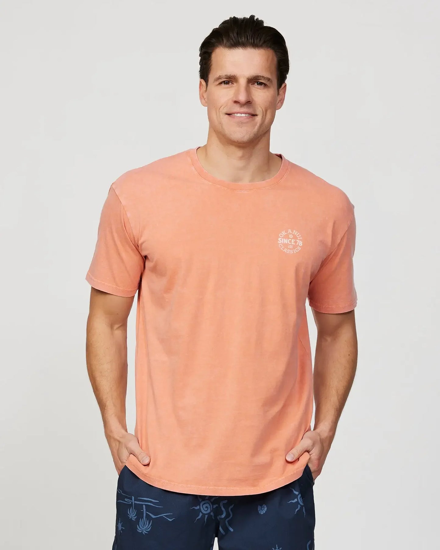 Closeup front view of a male model wearing the Okanui Mens Porthole Tee T-shirt in Washed Cedar