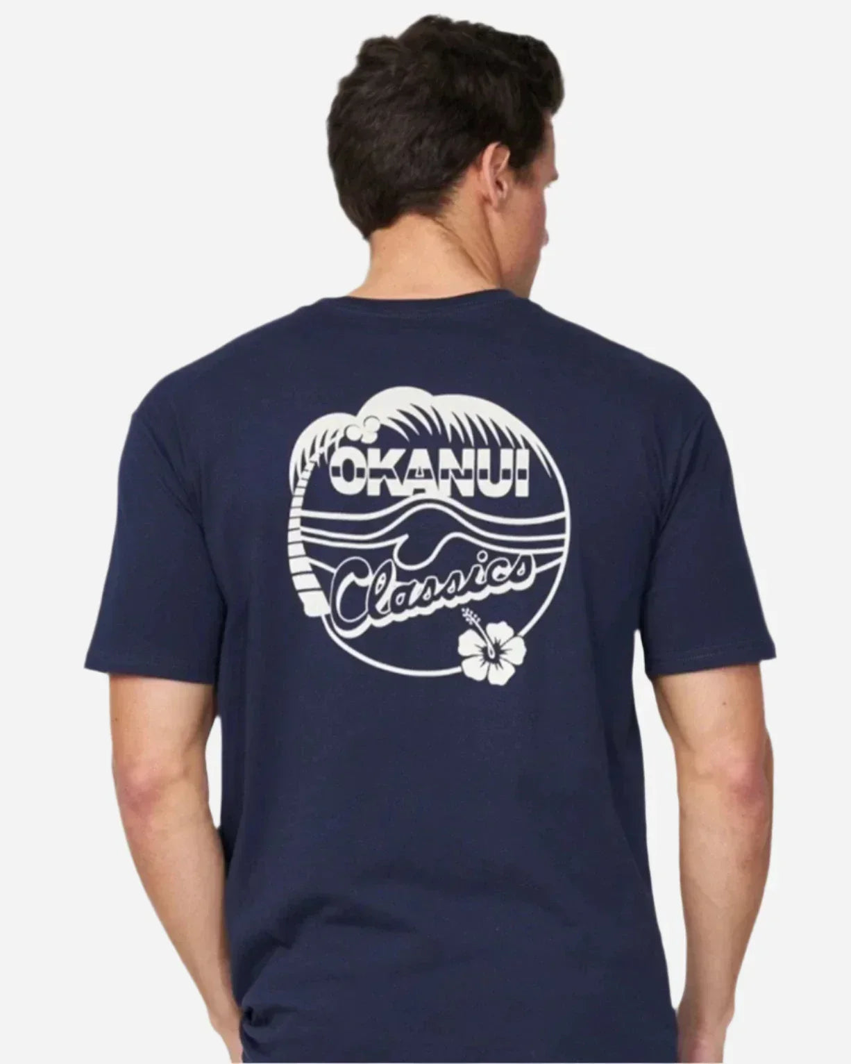 A back view of the Okanui Mens Classic Badge Tee in navy color showing the back print.