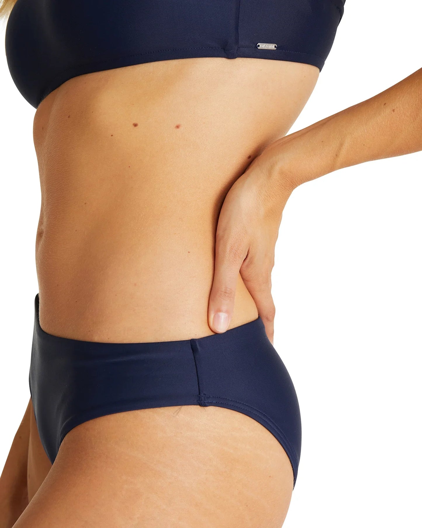 Close up left side view of the Okanui womens brief style bikini bottom swimsuit in Navy