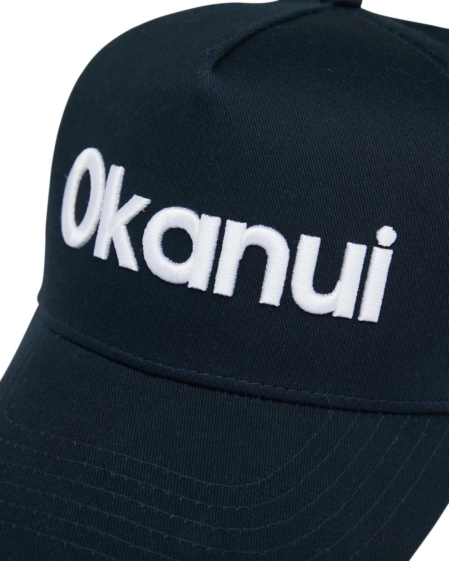 Close up view of the Okanui All day snapback trucker cap for mens in Navy color