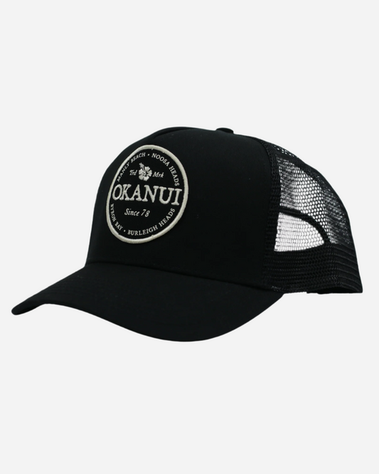 Front view of the Okanui Snapback Trucker Cap in Black Color