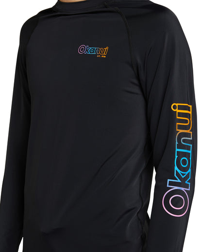 Closer details of Front view of Okanui Boy's spring long sleeve rashie in black with rainbow print.