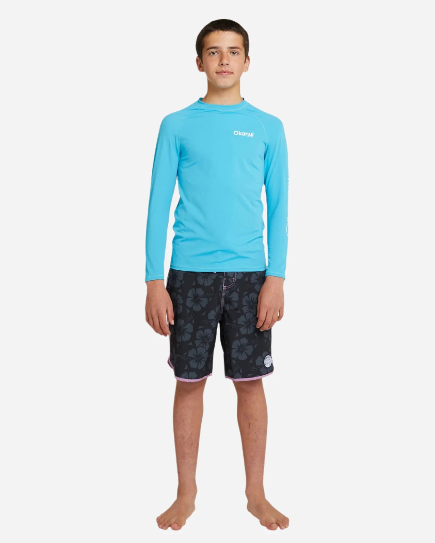 The front view details of Okanui Boy's spring long sleeve rashie in storm blue.