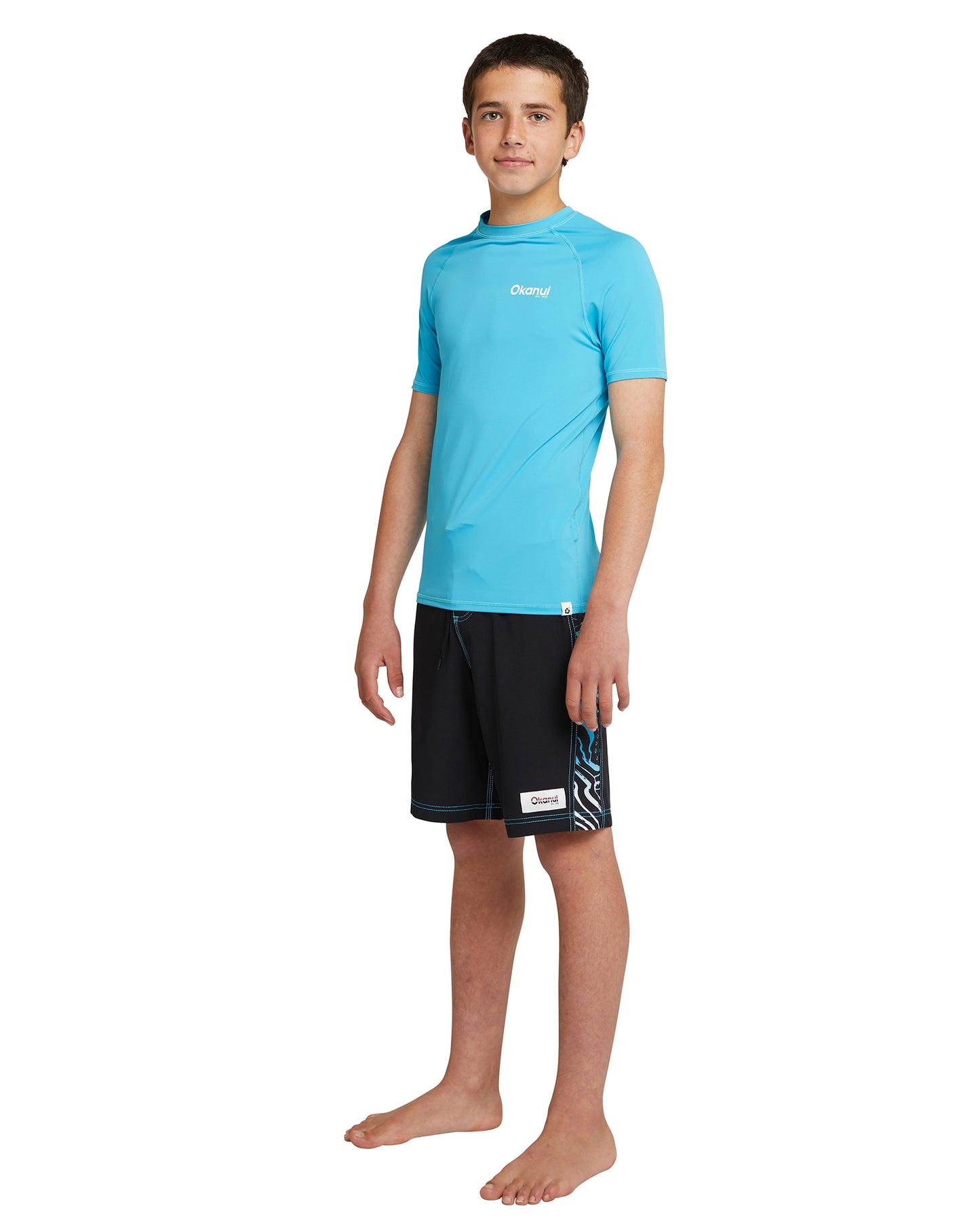 Full view of Okanui Boy's Spring short sleeve rashie top in storm blue.