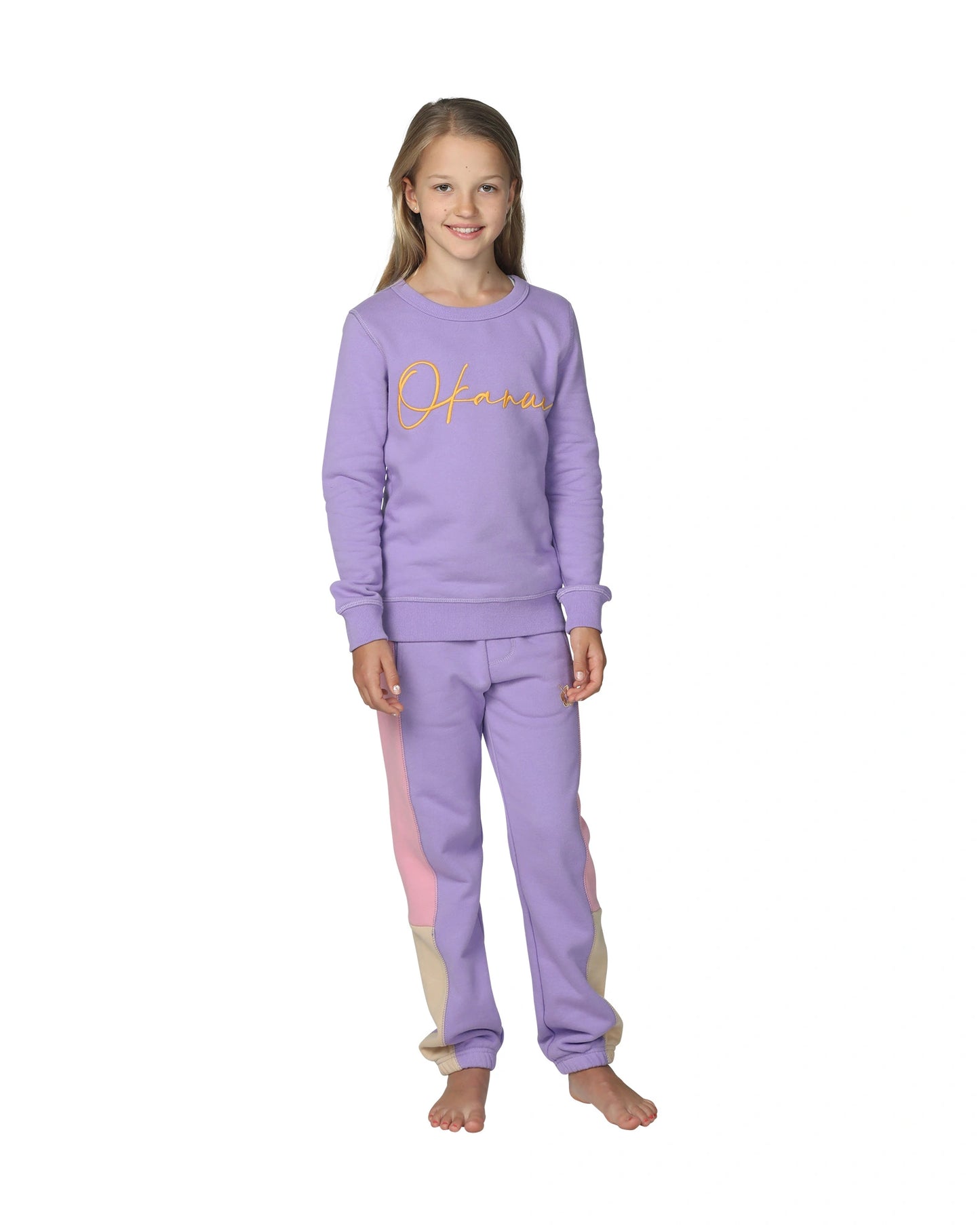 A lilac color sweater with Okanui logo in the middle. 