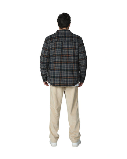 Checkered winter jacket with beige color pants showing the back view. 