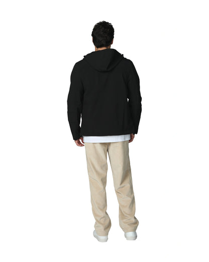 Mens soft shell jacket in color black with white shirt and beige pants showing the back view. 