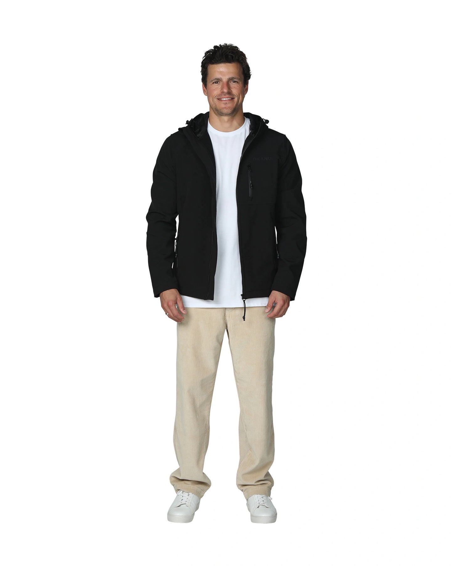 Mens soft shell jacket in color black with white shirt and beige pants. 