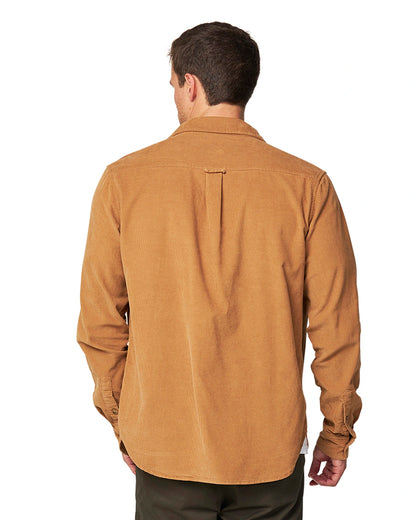 A a closer back view of a male model wearing the Okanui Corduroy Ledge Long Sleeve Shirt in Sand colour.