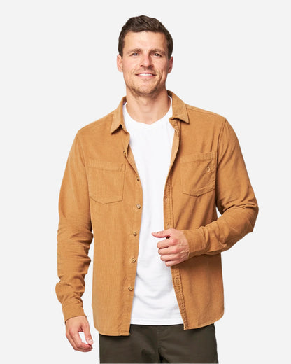 A male model wearing the unbuttoned Okanui Corduroy Ledge Long Sleeve Shirt in Sand colour.