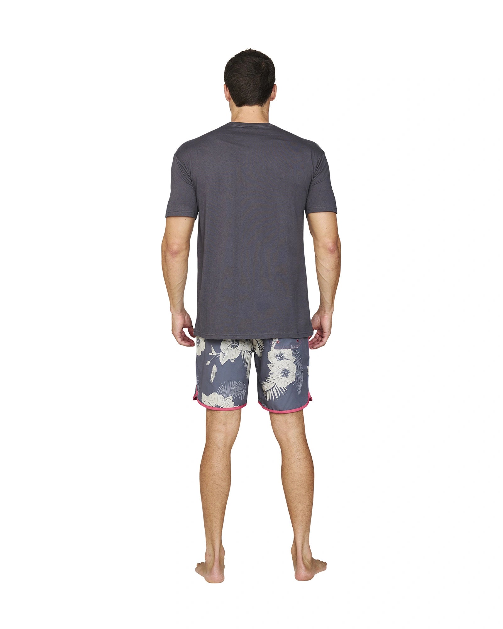 Back view of a male model wearing the Okanui Noosa Retro Boardrider Boardshort in Flint Stone color and a grey color t-shirt.