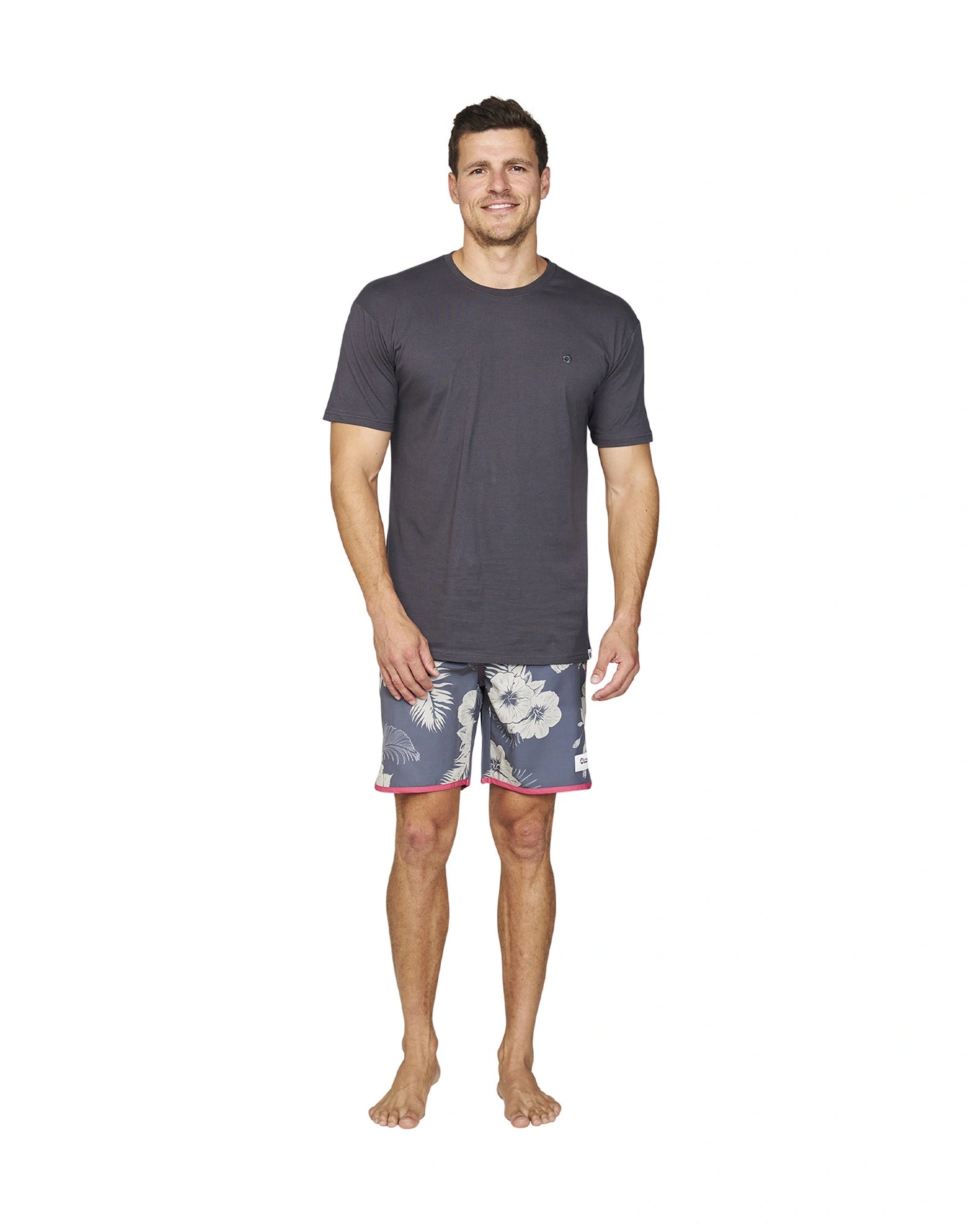 Front view of a male model wearing the Okanui Noosa Retro Boardrider Boardshort in Flint Stone color and a grey color t-shirt..