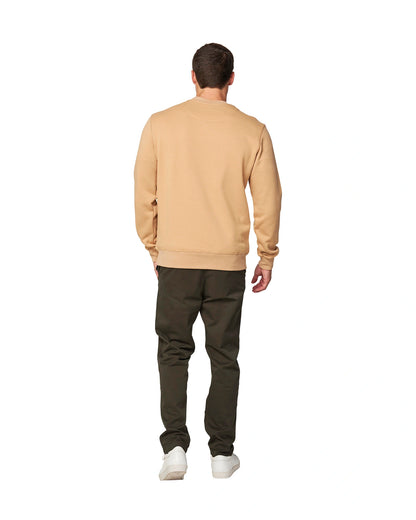 a man with dark pants and a beige Okanui sweatshirt that showing his back.