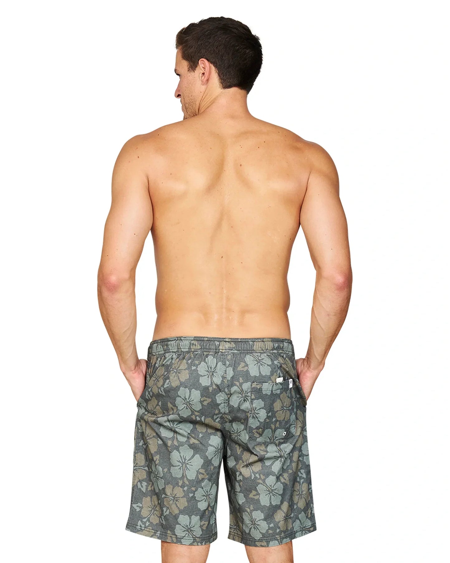Back view of a shirtless male model with his hands in the pockets of the Okanui Stonewall Heritage Walk Short in Forest colour.