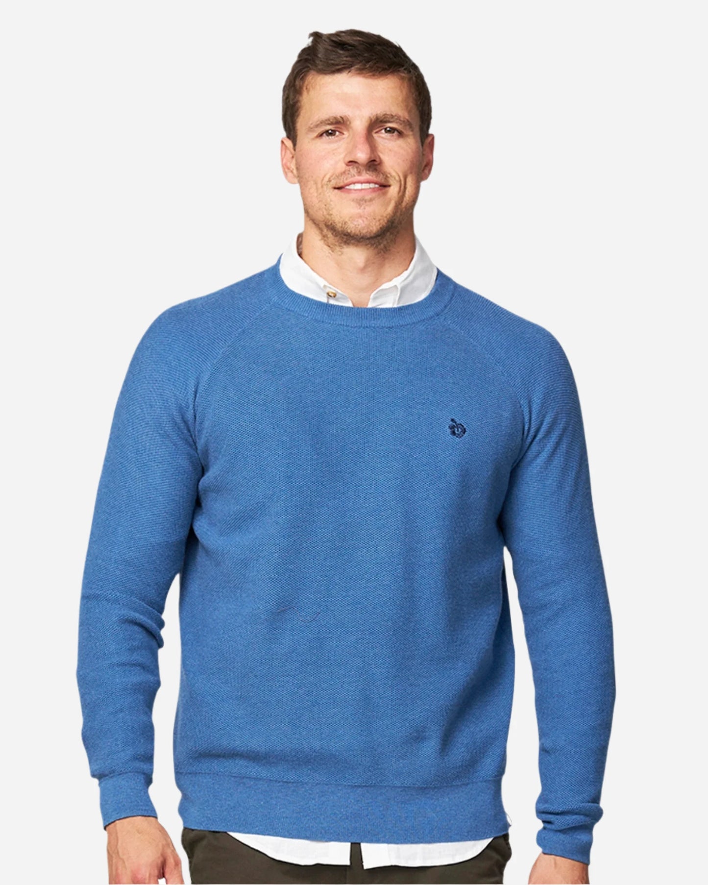 A male model wearing the Okanui Anchor Knit in Blue Marle color.