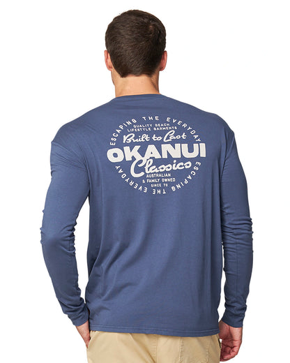 Close up back view of a male model wearing the Okanui long sleeve T-shirt for men in Washed Navy color