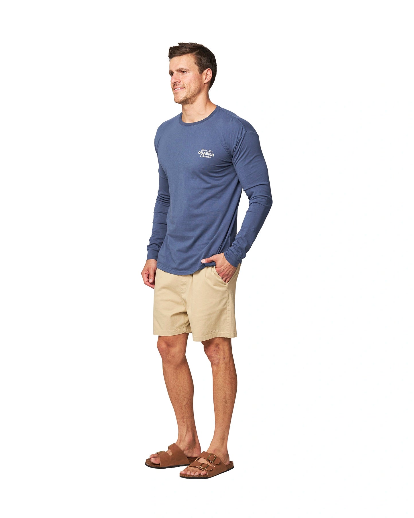 Front-Left angle view of a male model wearing the Okanui Last Stand long sleeve t-shirt in Washed Navy color