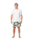 Full body front view of a male model wearing a white t-shirt top and Okanui Way Back When stretch swim shorts in Navy Lime color