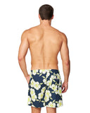 Back view of a half naked male model wearing the Okanui Way Back When stretch swim shorts in Navy Lime color