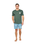 A man wearing a green t-shirt and the Okanui Sketch Stretch Swim Shorts in Steel Stone colour.