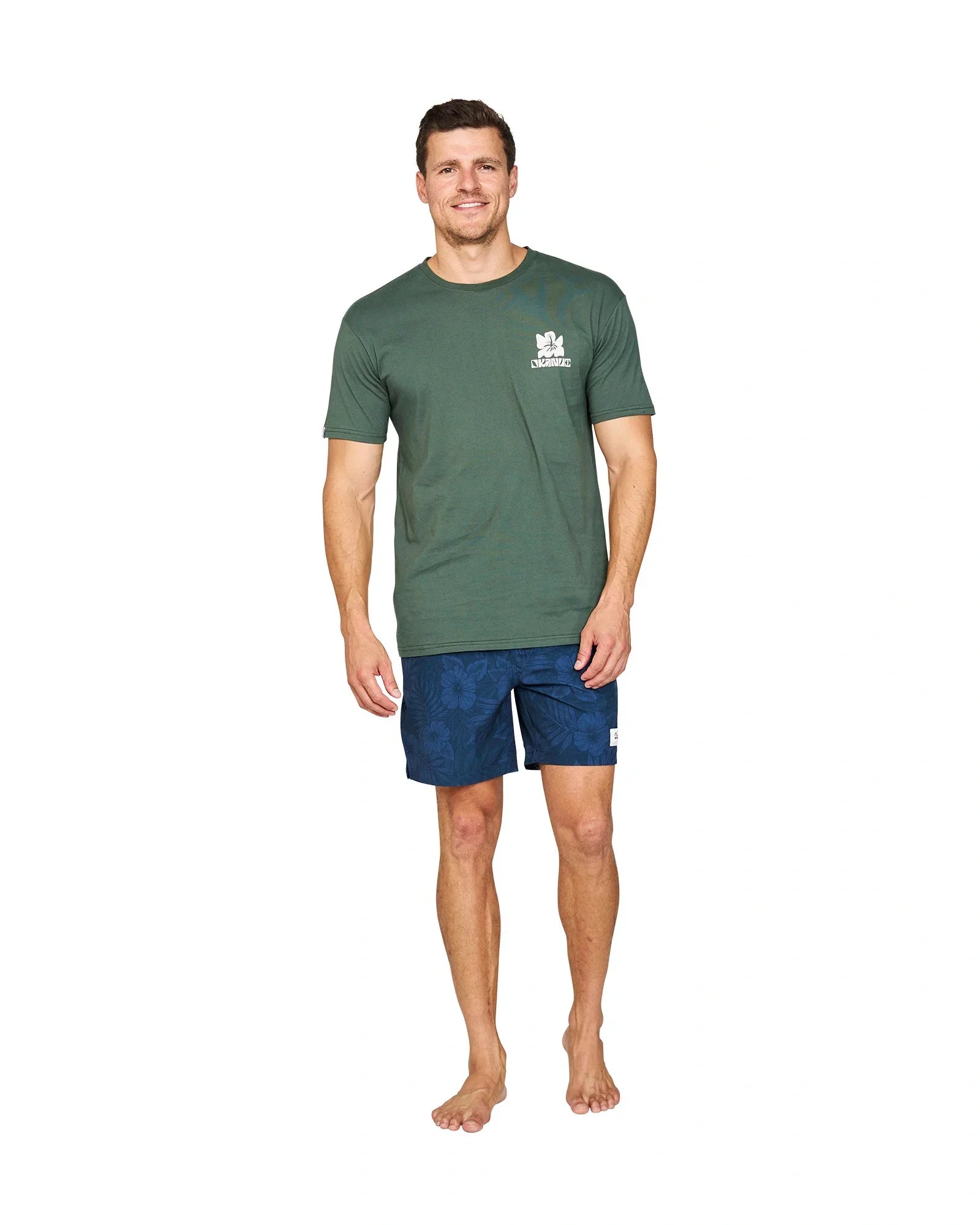 A casual pose of a male model wearing the Okanui Jungle T-Shirt in Forest Colour