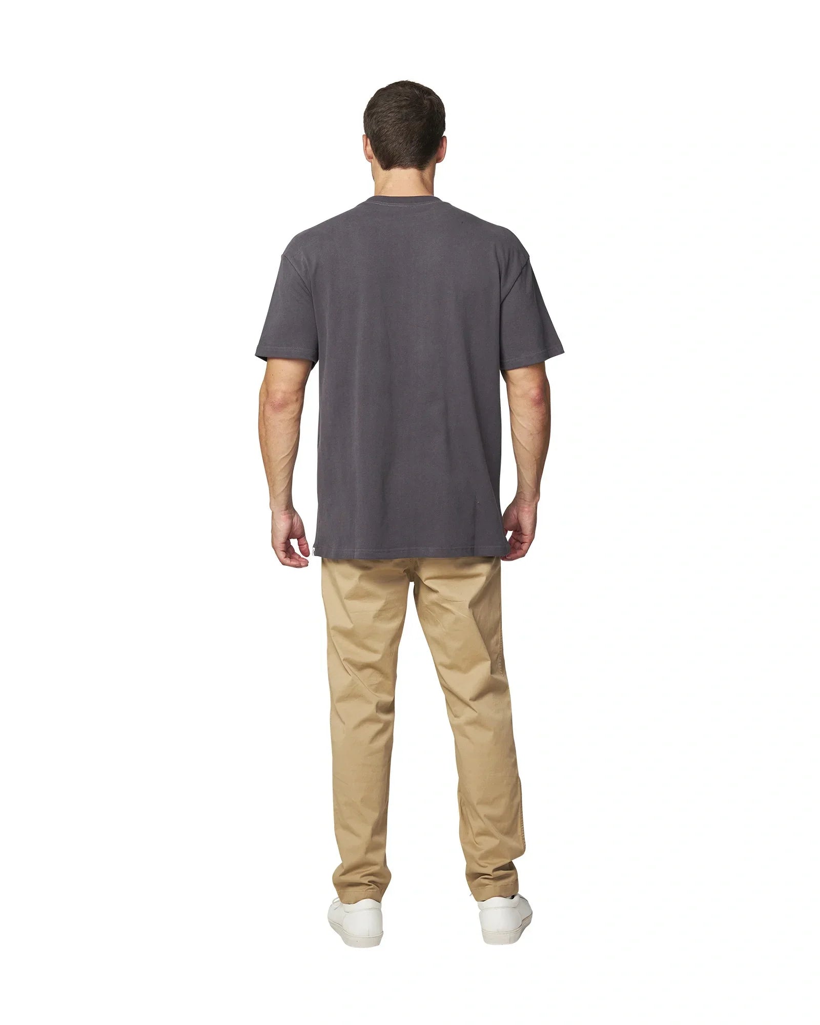 Front back view of the Okanui Men's Cube Heavy Weight Tee in Washed Iron colour paired with khaki pants and white shoes.
