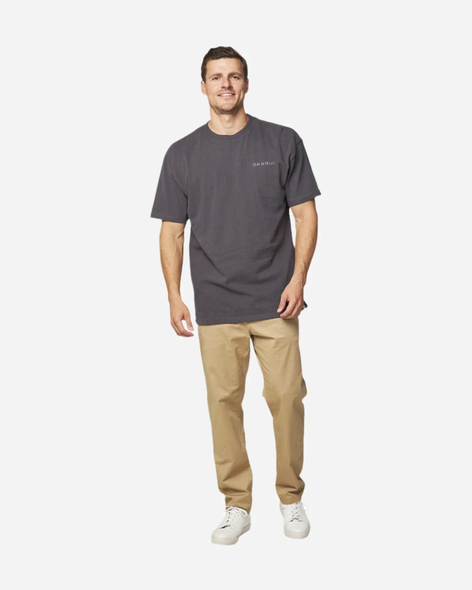 Front full view of the Okanui Men's Cube Heavy Weight Tee in Washed Iron colour paired with khaki pants and white shoes.