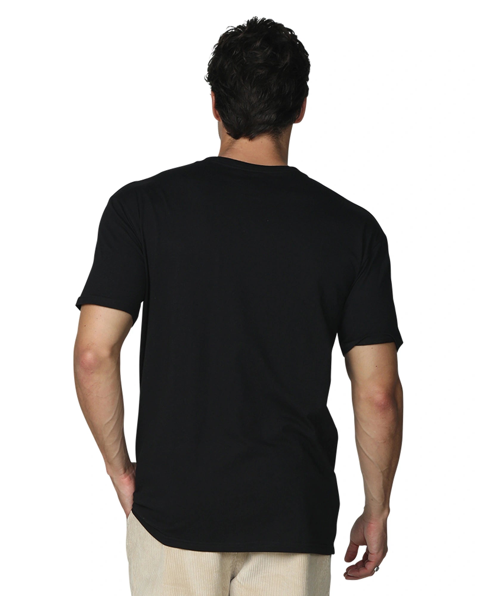 A close up back view of a male model with his hand in his pocket wearing the the Okanui Mens Staple Tee in Black colour.