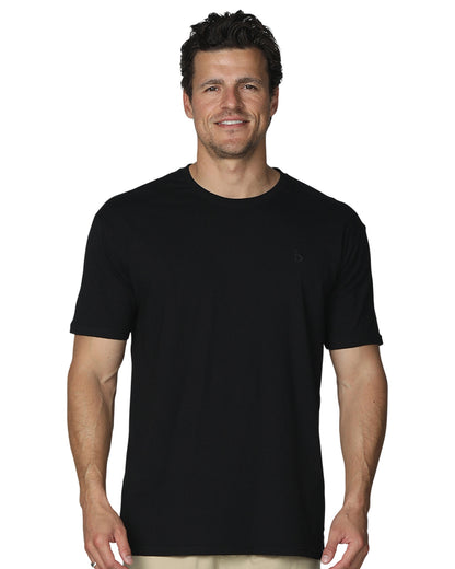 A close up front view of a smiling male model wearing the the Okanui Mens Staple Tee in Black colour.