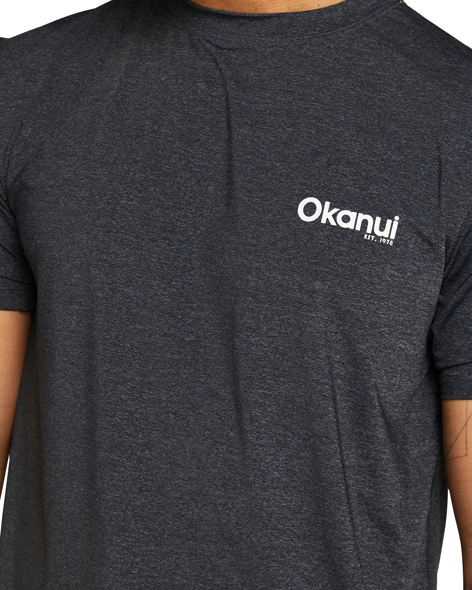 Closer details for Okanui Men's spring short sleeve rashie in color black. 