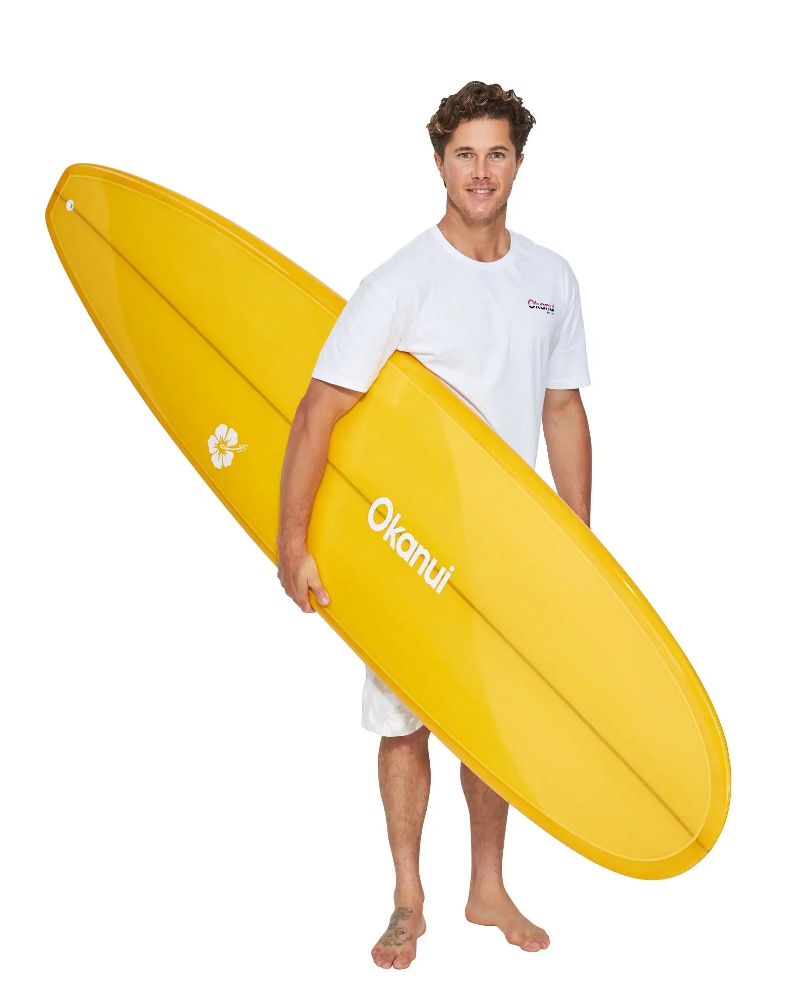 Male model in white shirt holding the Okanui Mustard Mini Mal Surfboard 7'6"