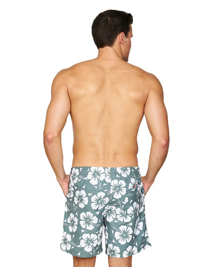 A back view of a male model wearing the Okanui Hibiscus Swimshorts in washed khaki colour.