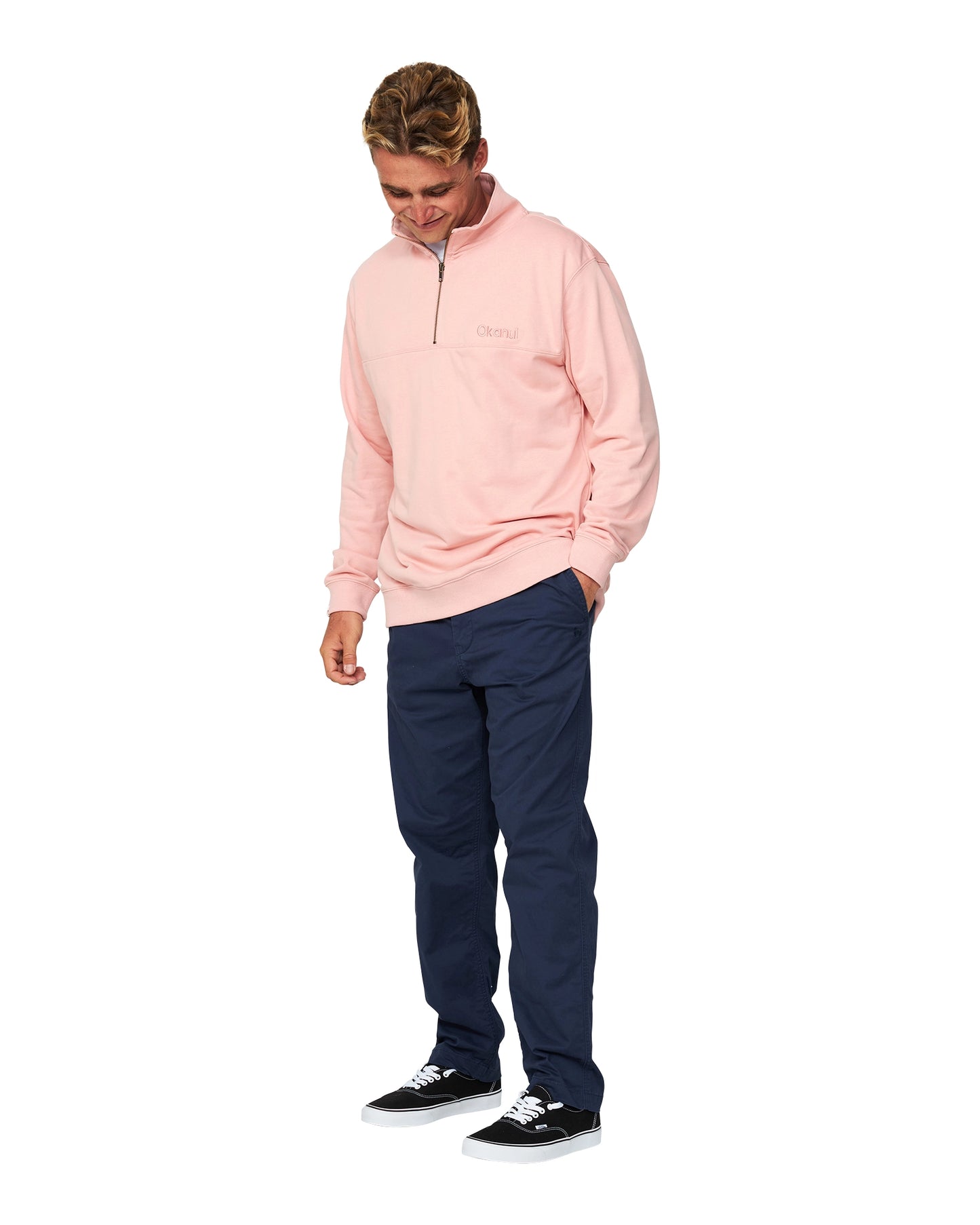 A male model looking down pose wearing the Dusty Pink colour Okanui Clubhouse Crew Sweater.