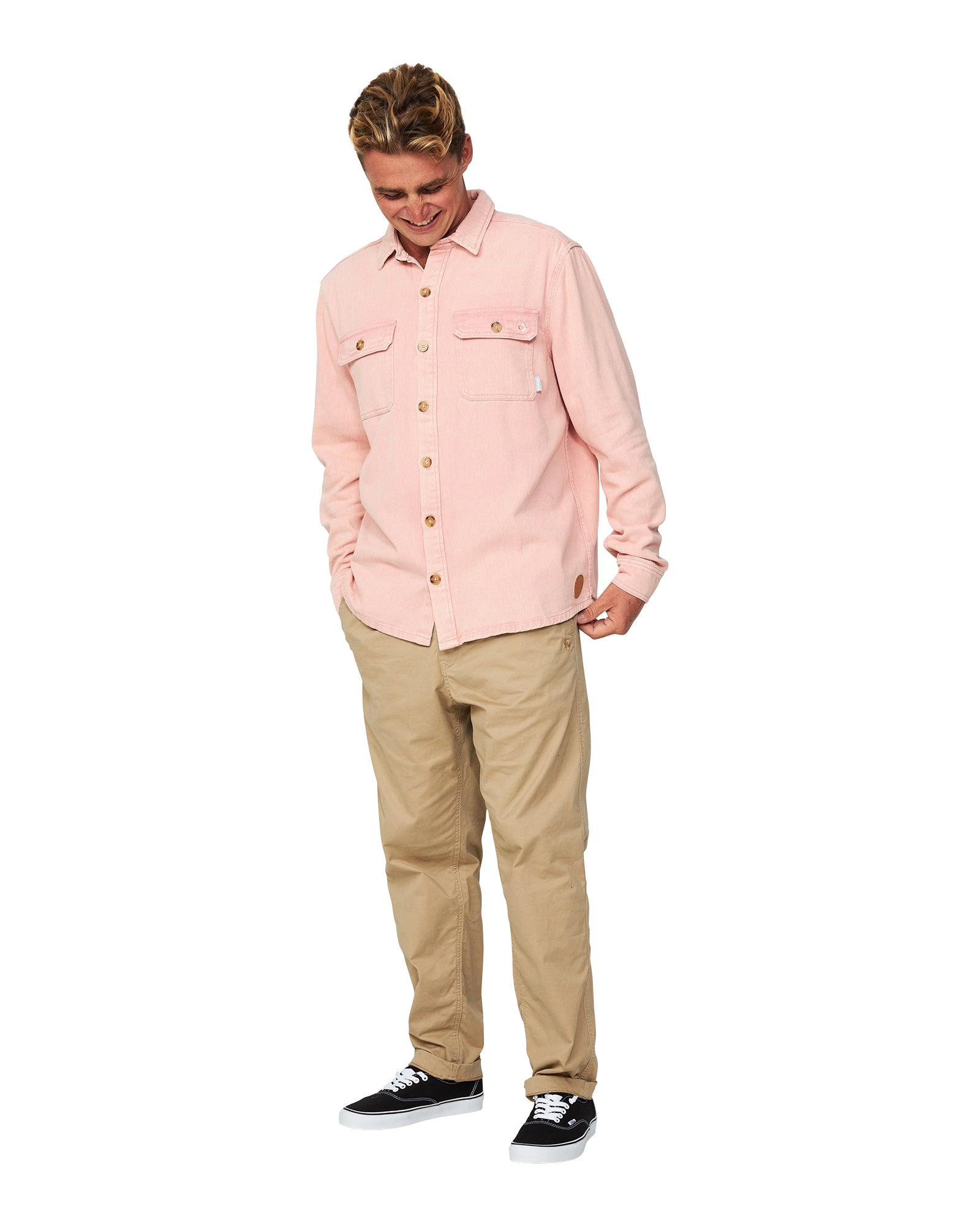 A male model looking down pose wearing the Okanui Deck Long Sleeve Shirt.