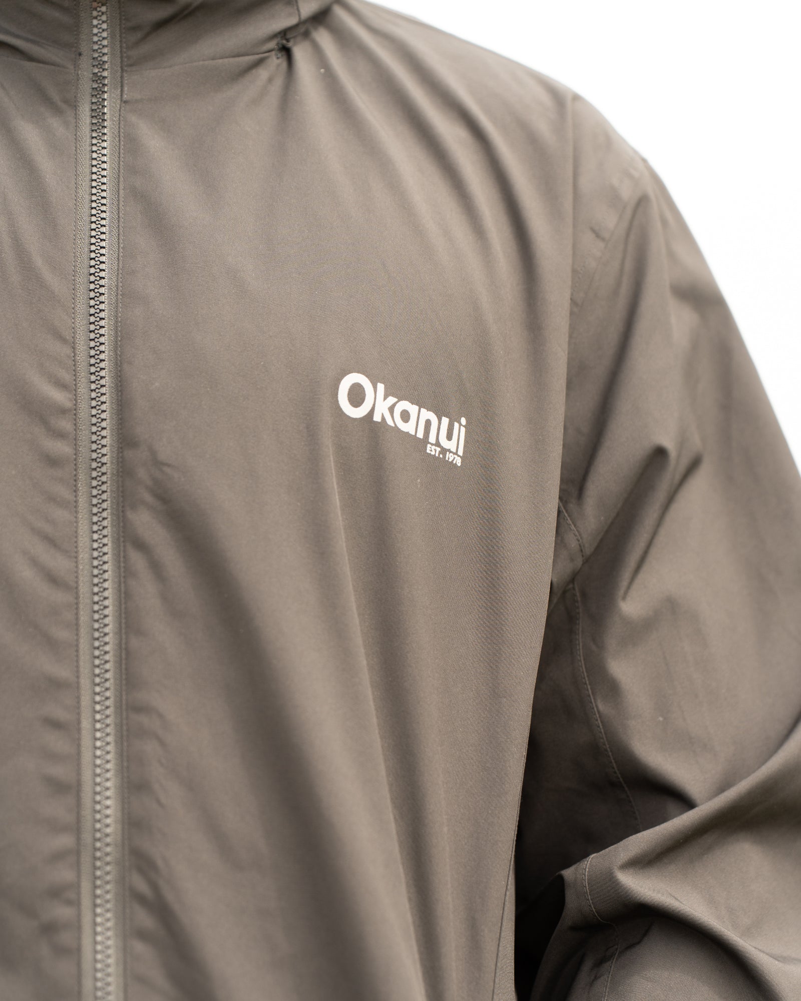 Mens surf jacket in black with Okanui logo on the chest. 