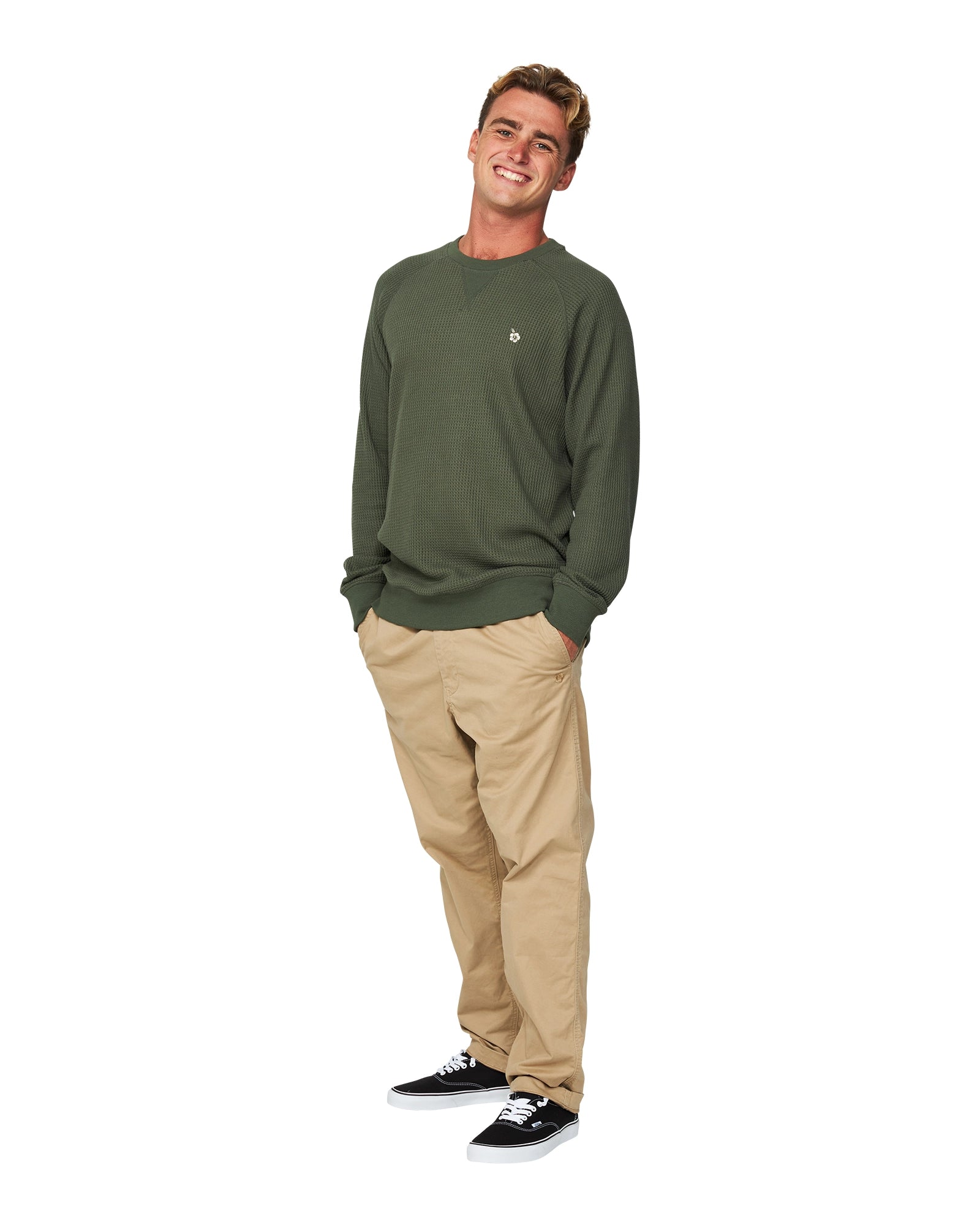 A male model slightly side view posing wearing the Okanui Waffle Jumper Crew in Forrest Green colour.